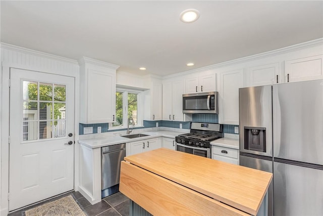 351 Jefferson Ave, Perinton, NY 14450 - kitchen with appliances with stainless steel finishes, white cabinets, crown molding, dark tile patterned flooring, and recessed lighting