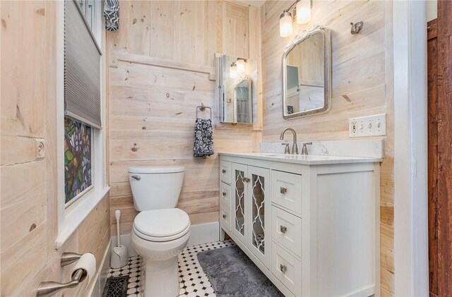 351 Jefferson Ave, Perinton, NY 14450 - half bath featuring vanity, wooden walls, and tile patterned floors