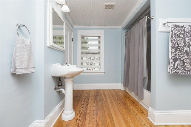 351 Jefferson Ave, Perinton, NY 14450 - full bathroom featuring wood finished floors, ornamental molding, and shower / bath combo with shower curtain