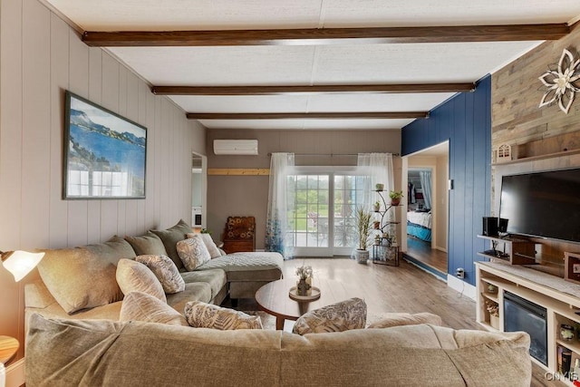 7118 Glass Factory Rd, Trenton, NY 13354 - living area featuring an AC wall unit, wood finished floors, wood walls, and beam ceiling
