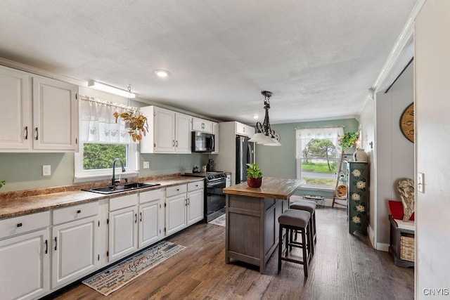 7118 Glass Factory Rd, Trenton, NY 13354 - kitchen with appliances with stainless steel finishes, white cabinetry, healthy amount of natural light, crown molding, and recessed lighting