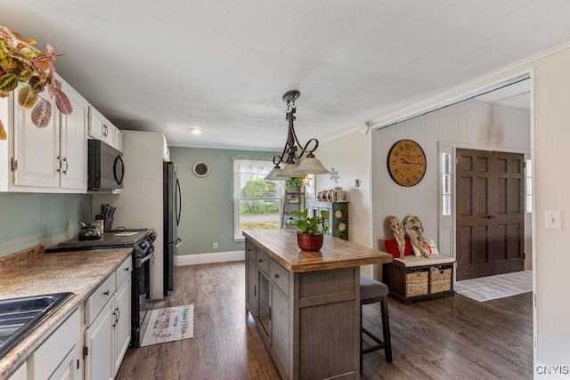 7118 Glass Factory Rd, Trenton, NY 13354 - kitchen with black appliances, ornamental molding, white cabinetry, butcher block countertops, and dark wood-type flooring