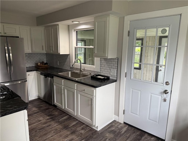 202 Klein St, Rochester, NY 14621 - kitchen with stainless steel appliances, dark countertops, decorative backsplash, and dark wood-style flooring