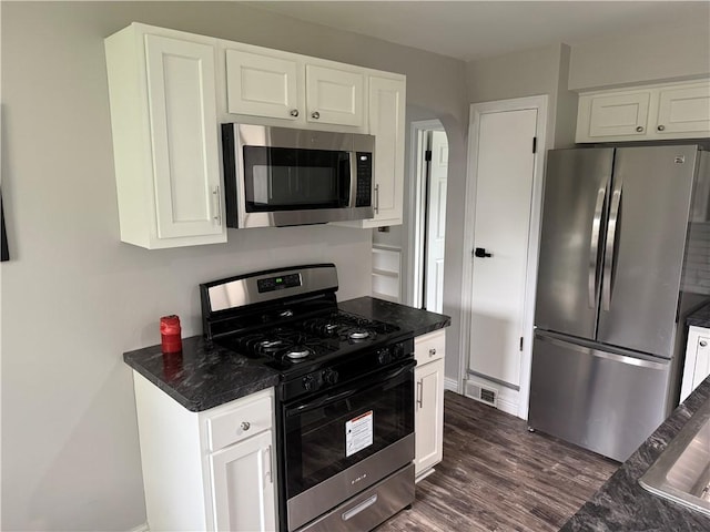 202 Klein St, Rochester, NY 14621 - kitchen with appliances with stainless steel finishes, white cabinetry, arched walkways, and dark wood-style floors