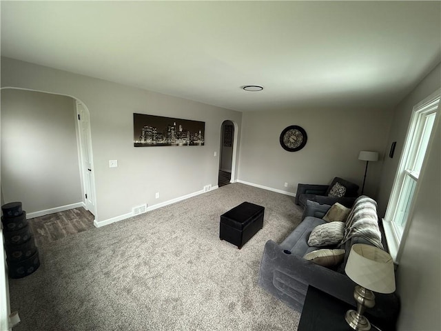 202 Klein St, Rochester, NY 14621 - living room with arched walkways and dark colored carpet