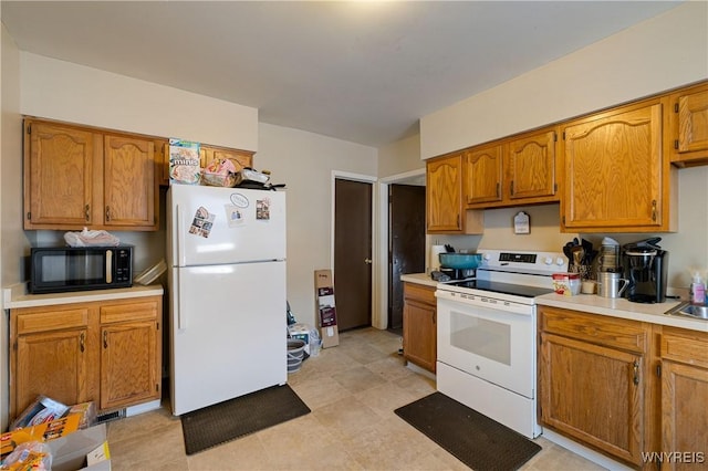 2320 Niagara St, Niagara Falls, NY 14303 - kitchen featuring white appliances, light countertops, and brown cabinets