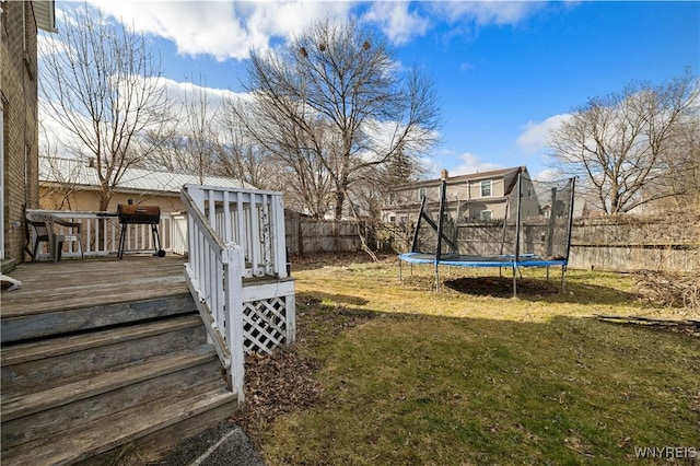 2320 Niagara St, Niagara Falls, NY 14303 - fenced backyard featuring a trampoline and a deck