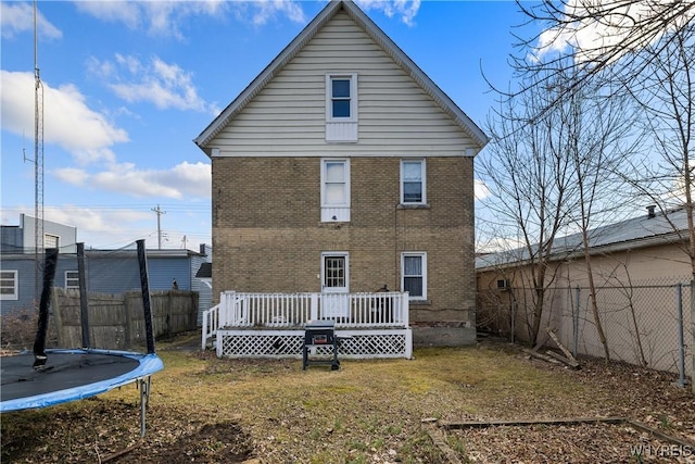 2320 Niagara St, Niagara Falls, NY 14303 - back of property with a trampoline, a deck, and brick siding