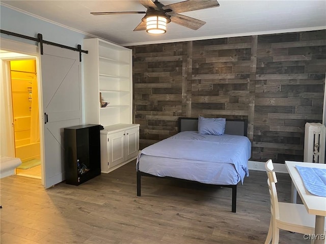 19 Genesee Ct Unit 19, Utica, NY 13502 - bedroom with ornamental molding, wood finished floors, radiator, a barn door, and a ceiling fan