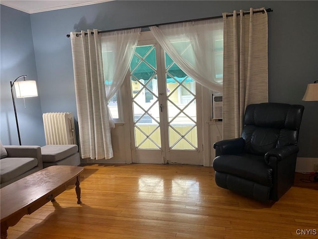 19 Genesee Ct Unit 19, Utica, NY 13502 - living area featuring radiator, light wood-type flooring, and crown molding