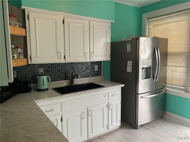 19 Genesee Ct Unit 19, Utica, NY 13502 - kitchen with stainless steel fridge with ice dispenser, backsplash, white cabinets, light wood-style flooring, and crown molding