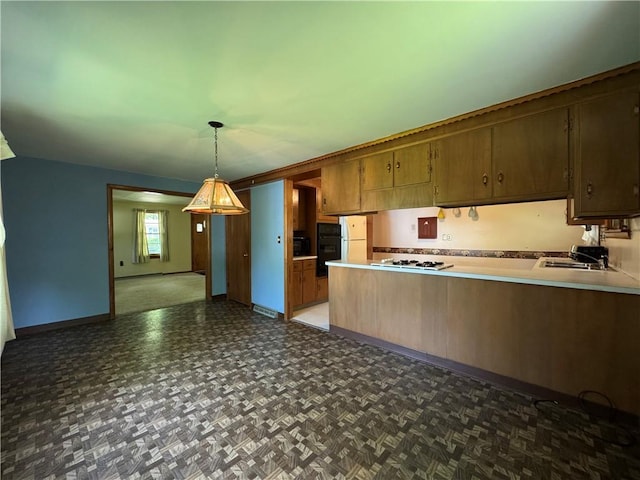 28 Mckune Ave, Foster-Town, PA 16701 - kitchen featuring white gas cooktop, light countertops, a peninsula, decorative light fixtures, and open floor plan