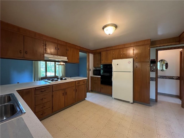 28 Mckune Ave, Foster-Town, PA 16701 - kitchen featuring black appliances, under cabinet range hood, light countertops, and brown cabinetry