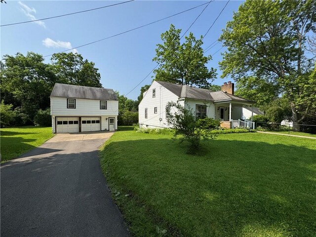 28 Mckune Ave, Foster-Town, PA 16701 - view of front of property with a chimney, a front yard, a garage, and an outdoor structure