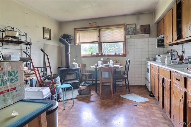 797 Hicks Rd, Warren, NY 13407 - kitchen featuring brown cabinets, a wood stove, and light countertops
