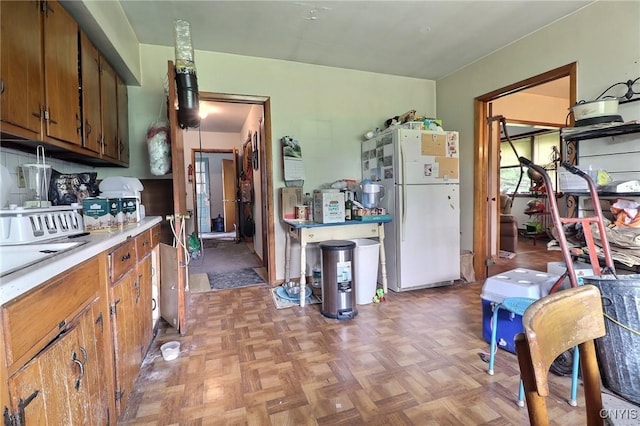 797 Hicks Rd, Warren, NY 13407 - kitchen featuring freestanding refrigerator, light countertops, and brown cabinets