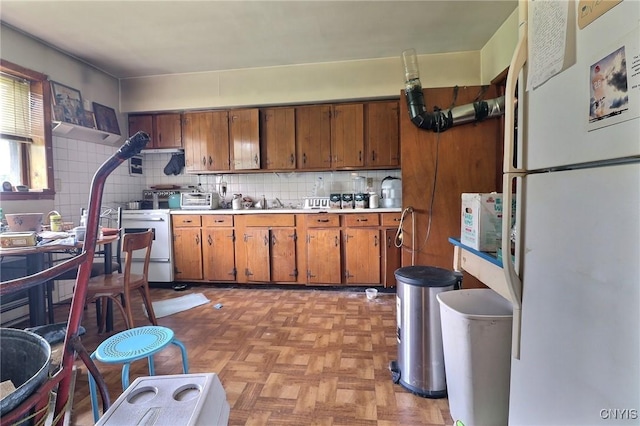 797 Hicks Rd, Warren, NY 13407 - kitchen featuring freestanding refrigerator, brown cabinets, decorative backsplash, and light countertops