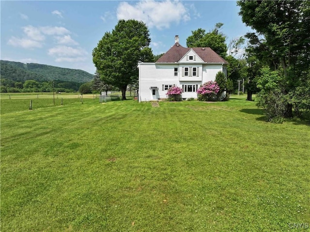 1902 E River Rd, Olean-Town, NY 14760 - rear view of property featuring a yard, a chimney, and a mountain view
