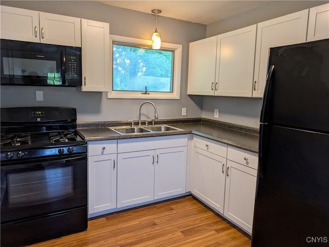 6 Cotty Dr, Dewitt, NY 13057 - kitchen with black appliances, dark countertops, white cabinets, light wood finished floors, and pendant lighting