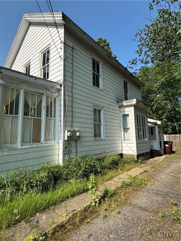 32 Broad St, Gloversville, NY 12078 - view of home's exterior with a sunroom