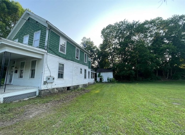 129 N Main St, Manheim, NY 13329 - view of side of property with a lawn and covered porch