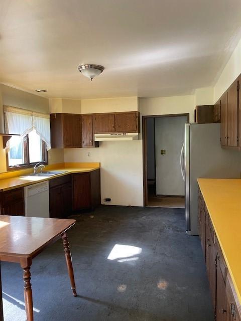 824 Franklin St, Skaneateles, NY 13152 - kitchen with under cabinet range hood, white dishwasher, freestanding refrigerator, light countertops, and concrete flooring