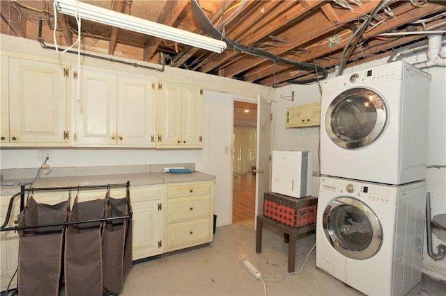 106 Weston Ln, Erwin, NY 14870 - laundry room with stacked washer / dryer and cabinet space
