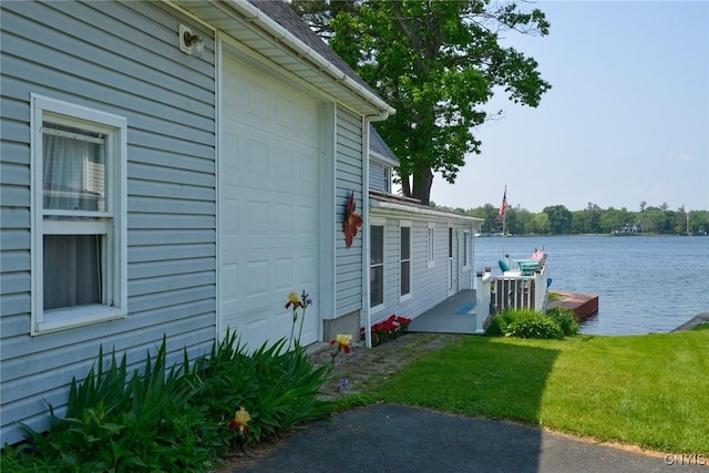 21157 Home St, Alexandria, NY 13607 - view of property exterior with a water view, a yard, and a garage