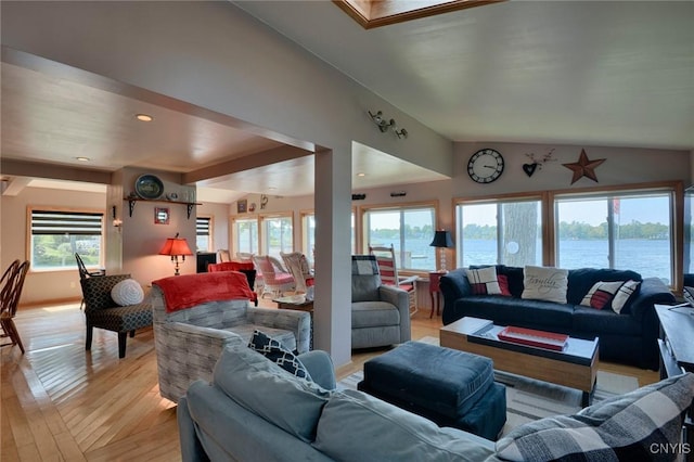 21157 Home St, Alexandria, NY 13607 - living room featuring plenty of natural light, light wood-style flooring, a water view, lofted ceiling, and recessed lighting