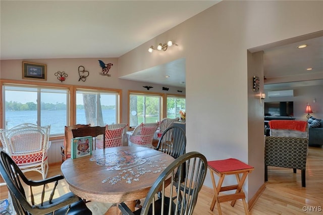 21157 Home St, Alexandria, NY 13607 - dining room with light wood-type flooring, a water view, and lofted ceiling