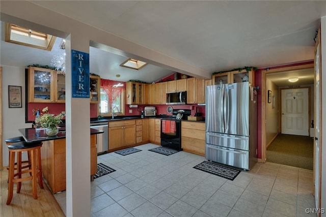 21157 Home St, Alexandria, NY 13607 - kitchen featuring appliances with stainless steel finishes, dark countertops, glass insert cabinets, and light tile patterned floors