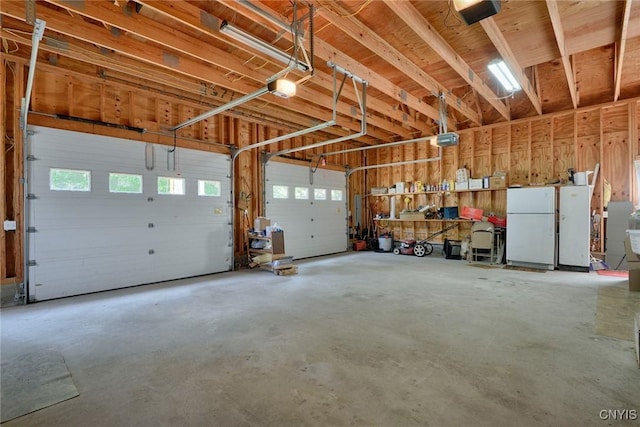 21157 Home St, Alexandria, NY 13607 - garage featuring freestanding refrigerator and a garage door opener