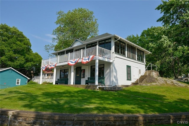 21157 Home St, Alexandria, NY 13607 - rear view of house with stairs, a lawn, and covered porch