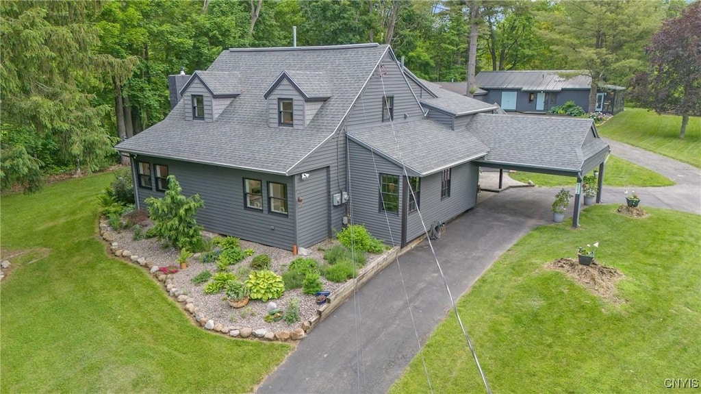4384 Cedarvale Rd, Onondaga, NY 13215 - view of front facade with an attached carport, driveway, a front lawn, and a shingled roof