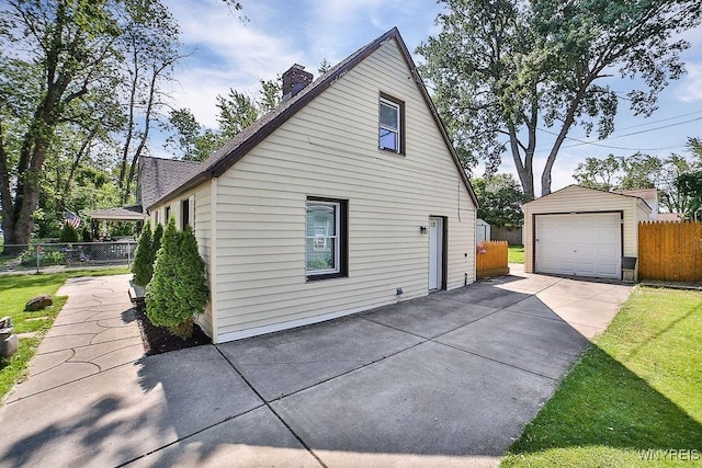 235 Koenig Rd, Tonawanda-Town, NY 14150 - view of side of property with an outbuilding, a detached garage, driveway, and a chimney