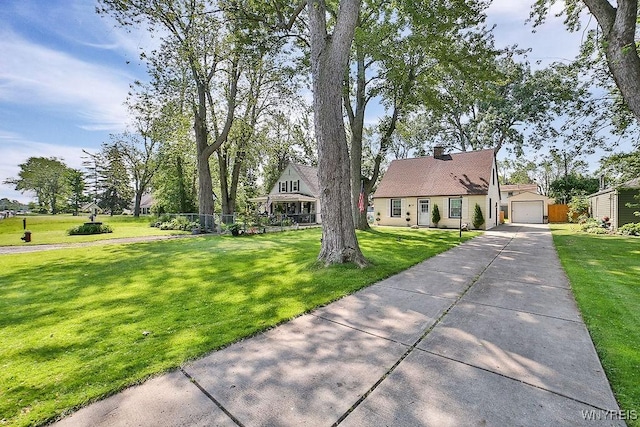 235 Koenig Rd, Tonawanda-Town, NY 14150 - view of front of house featuring an outbuilding, concrete driveway, a detached garage, and a chimney