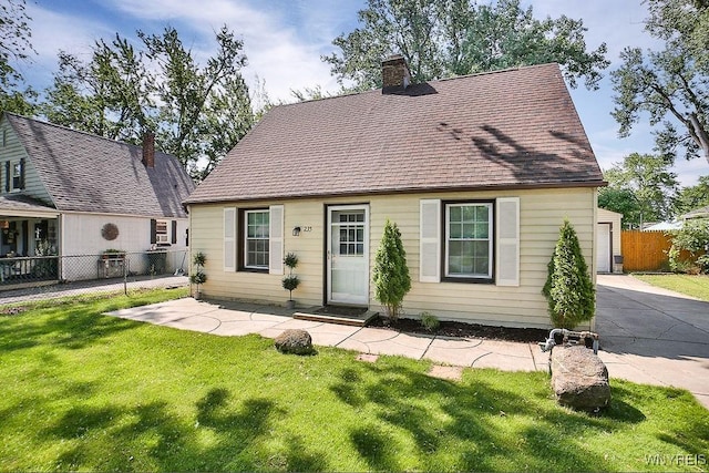 235 Koenig Rd, Tonawanda-Town, NY 14150 - cape cod house featuring a chimney, roof with shingles, and driveway