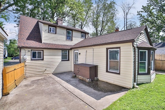 235 Koenig Rd, Tonawanda-Town, NY 14150 - back of house with a chimney, a patio area, and a shingled roof