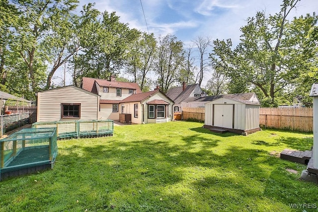 235 Koenig Rd, Tonawanda-Town, NY 14150 - back of house featuring a fenced backyard, a chimney, and a storage unit