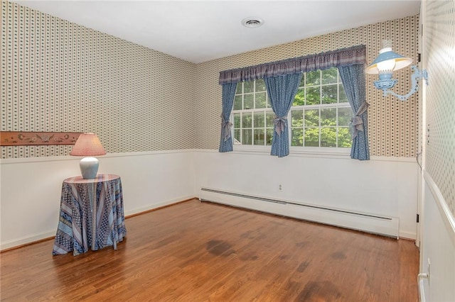 285 Panorama, Penfield, NY 14625 - unfurnished room featuring baseboard heating, wallpapered walls, and wood finished floors