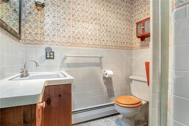 285 Panorama, Penfield, NY 14625 - bathroom featuring a baseboard heating unit, wallpapered walls, vanity, a wainscoted wall, and tile walls