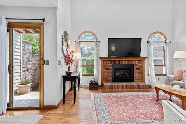 5810 Nobleton Cir, Onondaga, NY 13078 - living area with hardwood / wood-style flooring, a fireplace, and a high ceiling