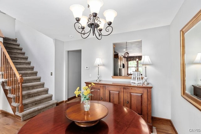 5810 Nobleton Cir, Onondaga, NY 13078 - dining room featuring a chandelier, stairway, and wood finished floors