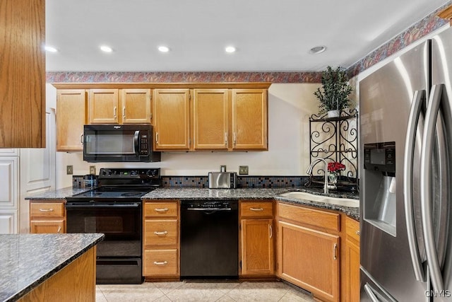 5810 Nobleton Cir, Onondaga, NY 13078 - kitchen with black appliances, dark stone counters, and light tile patterned flooring