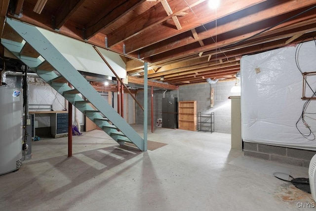 5810 Nobleton Cir, Onondaga, NY 13078 - unfinished below grade area with gas water heater, stairs, and concrete block wall