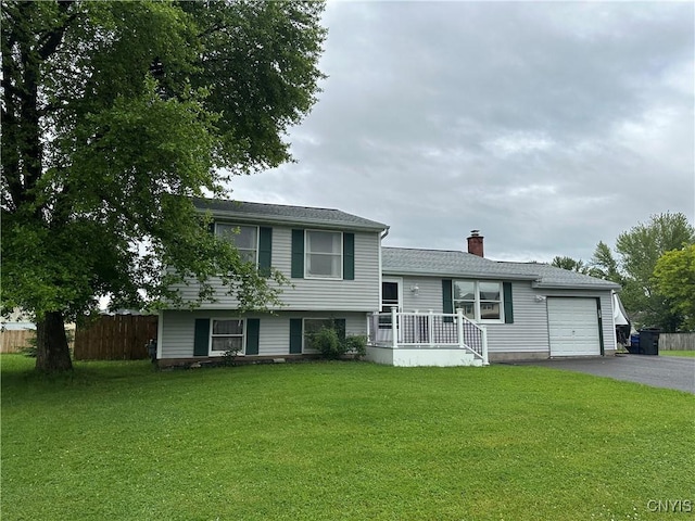 8071 Evesborough Dr, Clay, NY 13041 - split level home featuring driveway, an attached garage, and a chimney