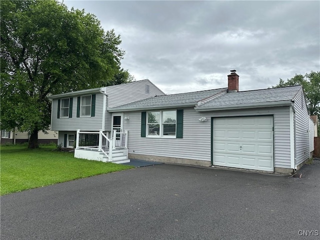 8071 Evesborough Dr, Clay, NY 13041 - split level home featuring a chimney, an attached garage, a front yard, a shingled roof, and driveway