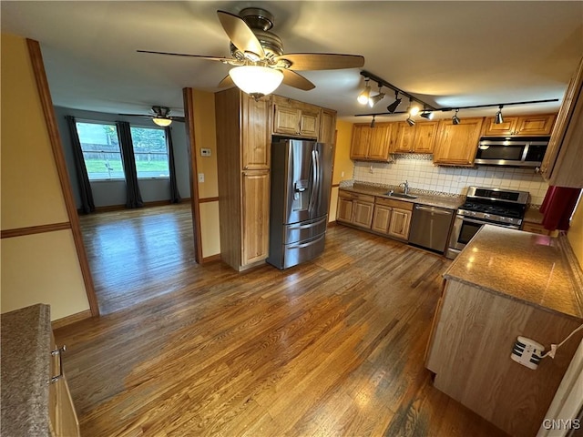 8071 Evesborough Dr, Clay, NY 13041 - kitchen featuring stainless steel appliances, dark wood finished floors, backsplash, brown cabinets, and a ceiling fan
