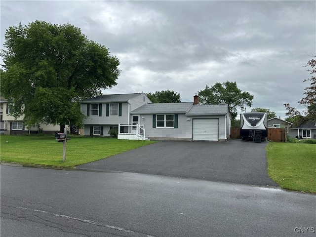 8071 Evesborough Dr, Clay, NY 13041 - tri-level home with a garage, a chimney, driveway, and a front yard