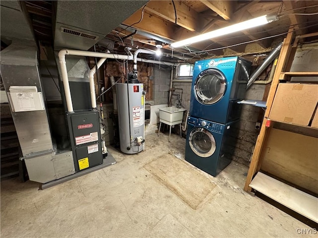 8071 Evesborough Dr, Clay, NY 13041 - basement with gas water heater, stacked washer / dryer, and heating unit